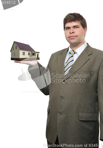 Image of businessman with house in hand