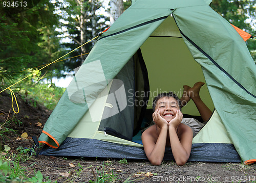 Image of happy boy in camping tent