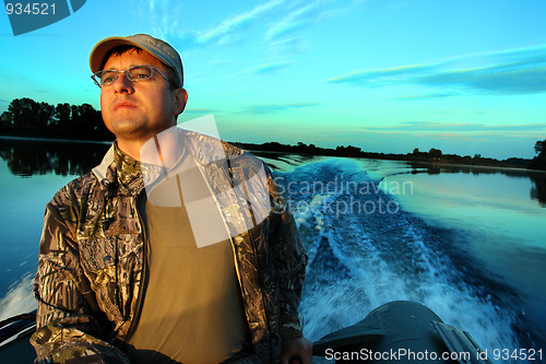 Image of fishing men at dawn looking into the distance