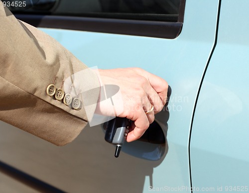 Image of men hand open car door 