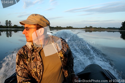 Image of men on boat with motor