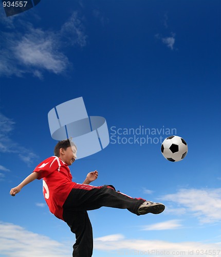 Image of asian boy playing football