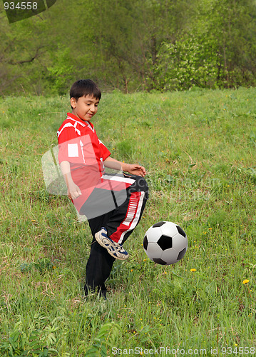 Image of asian boy playing football