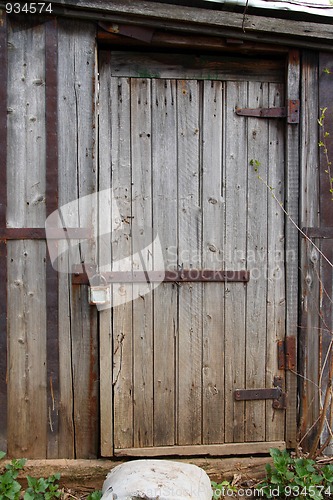 Image of closed wooden door of old shed