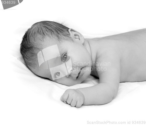Image of baby crawling on white sheet