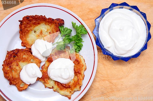 Image of potato pancakes with sour cream