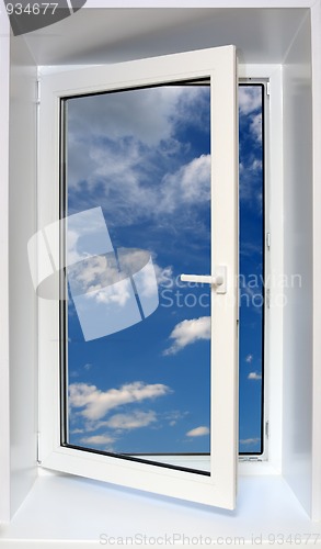 Image of view on blue sky through open plastic window