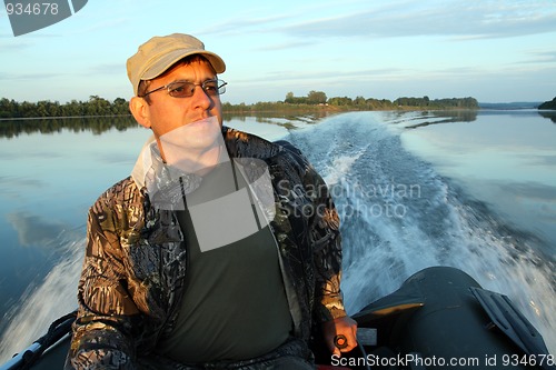 Image of men on boat with motor