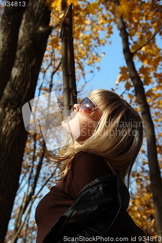 Image of beautiful girl on autumn background