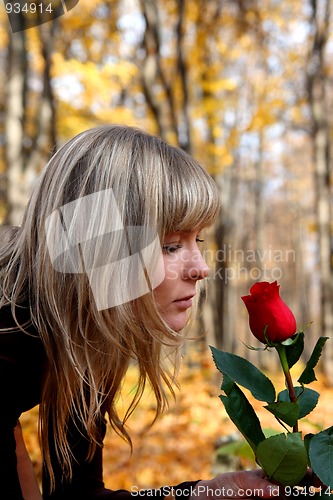 Image of girl with rose in autumn park