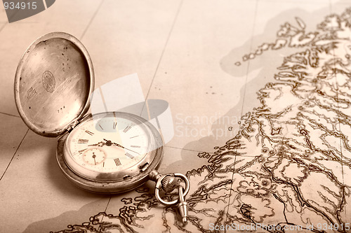 Image of Old silver watch on old map