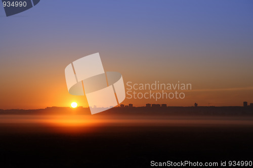 Image of sunrise over far town