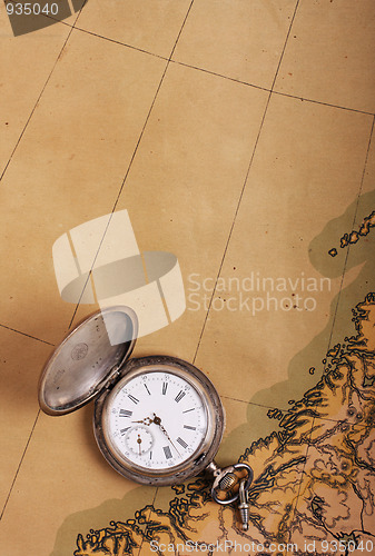 Image of Old silver watch on ancient map
