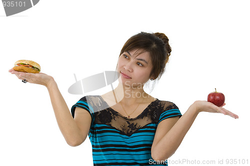 Image of woman with hamburger and apple