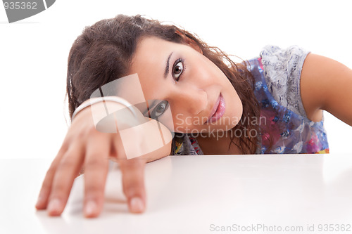 Image of beautiful young woman, her head resting on his arm