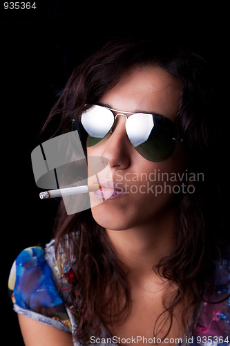 Image of Young, sexy brunette with cigarette and sunglasses