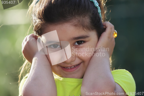 Image of Little girl closing ears