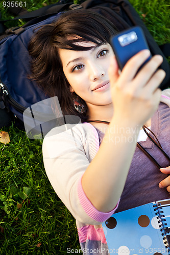 Image of Mixed race student texting