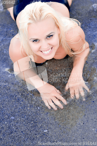 Image of blond woman lying in water