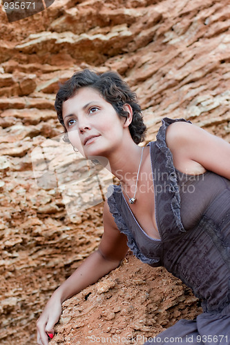 Image of attractive brunet woman among rocks