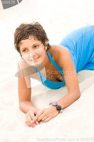 Image of attractive brunet woman in blue dress