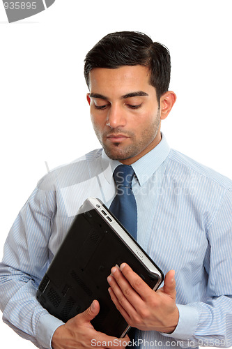 Image of Businessman holding laptop computer