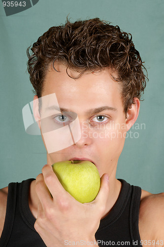 Image of Young man biting an apple