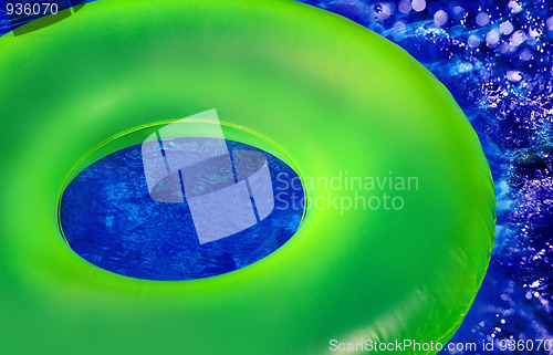Image of Green Inner Tube on Blue Pool Wate
