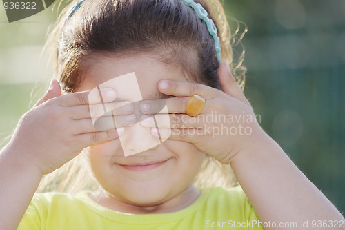 Image of Little girl closing eyes