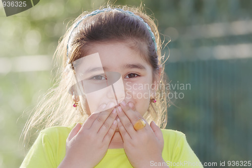 Image of Little girl closing mouth