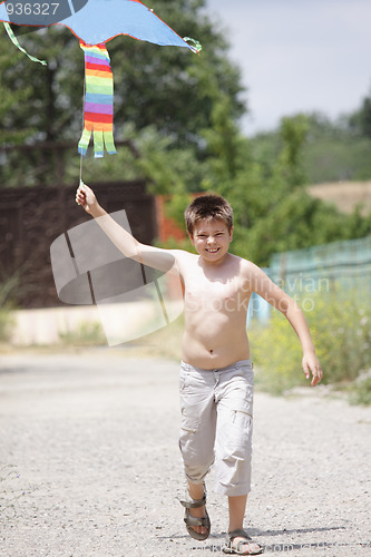 Image of Boy running with kite