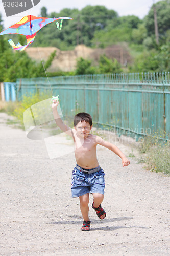 Image of Little boy flying kite