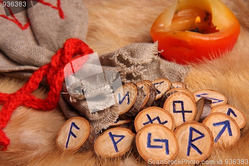 Image of Runes with pouch and candle close-up