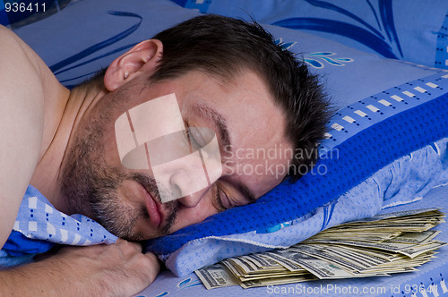 Image of man with money under his pillow