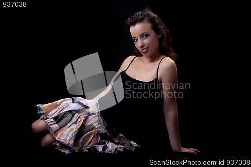 Image of young and beautiful woman  seated on floor