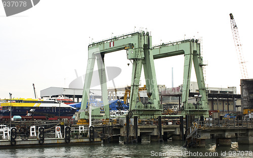 Image of container vessel moored in the port, no trademarks visible 