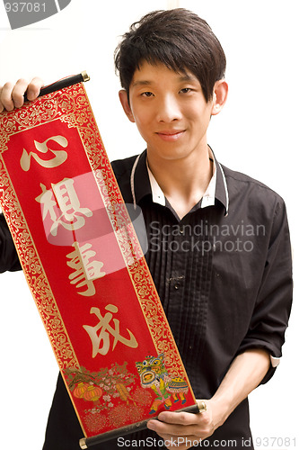 Image of Young Asian man holding chinese lucky word fora chinese new year