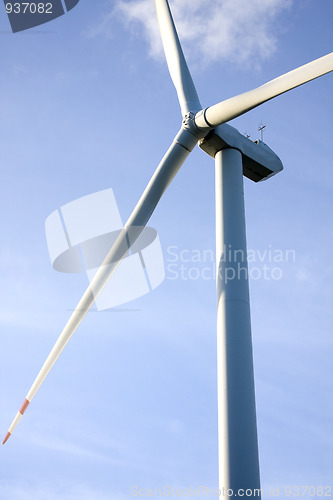 Image of wind turbine generating electricity on blue sky 