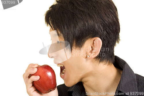 Image of Young Asian man eating apple