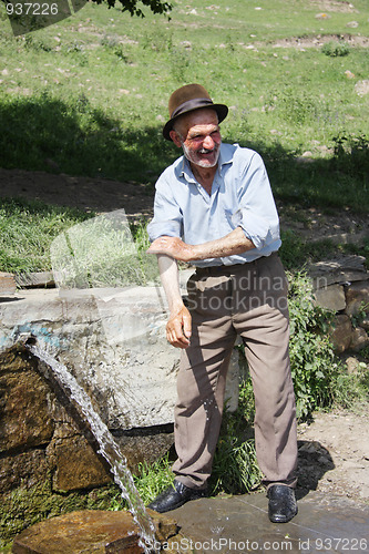 Image of Man washing hands at spring