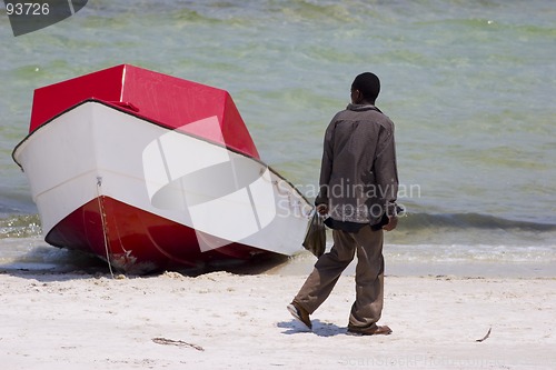 Image of African man looking at boat