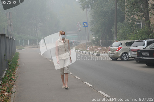 Image of Woman Walking in Thick Smog