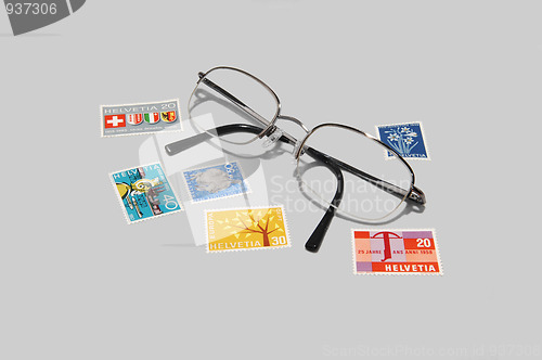 Image of Collectible stamps with eyeglasses.
