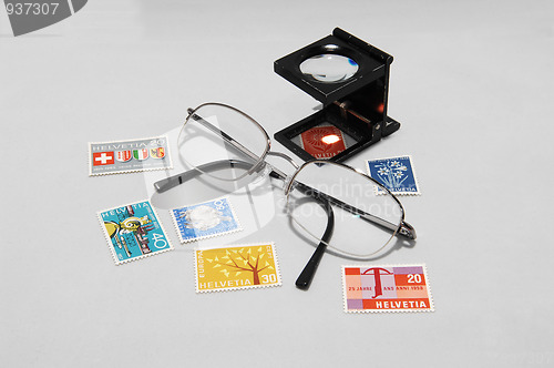 Image of Collectible stamps with eyeglasses.