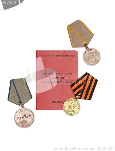 Image of Soviet communist party membership card surrounded by old medals isolated