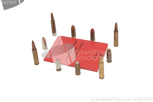 Image of Soviet communist party membership card surrounded by cartridges isolated