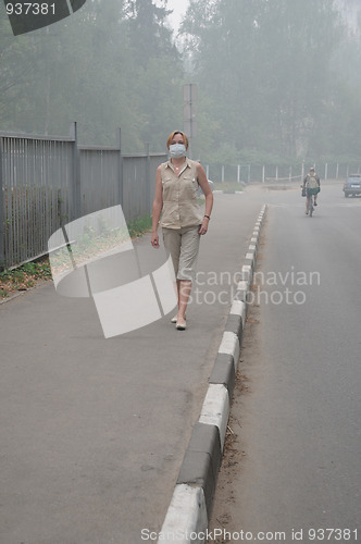 Image of Woman walking in Heavy Smog