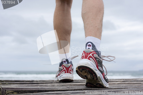 Image of Feet of runner on a beach