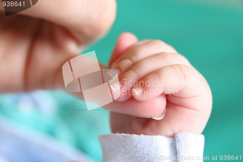 Image of new born Baby's hand gripping for mothers finger