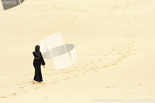 Image of Woman walking by desert routes